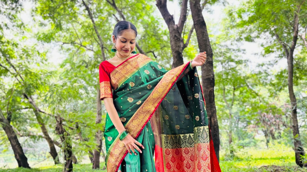 bedroom-bliss Woman in a beautiful traditional saree posing gracefully in a lush, green outdoor setting.